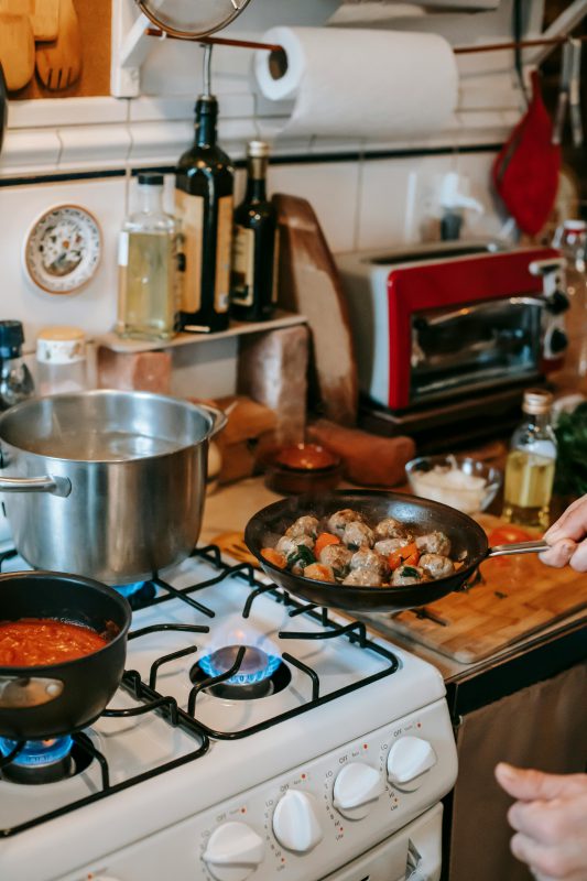 Crop person preparing lunch in house kitchen